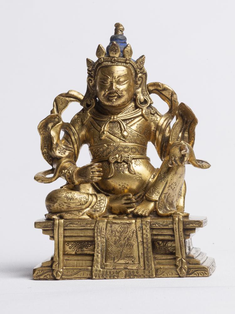 A GILT-BRONZE FIGURE OF HARMAPALA