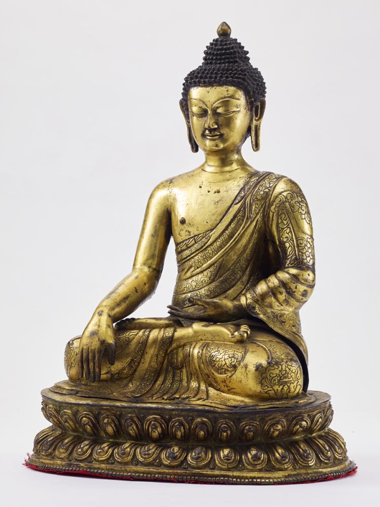 A GILT-BRONZE REPOUSSÉ FIGURE OF SHAKYAMUNI