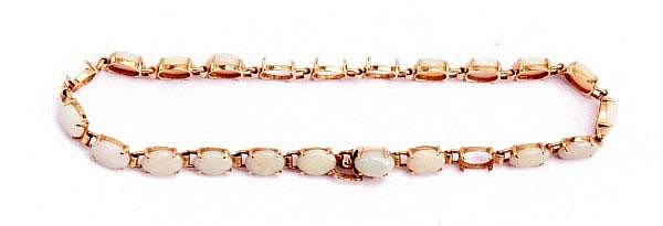 A 14ct gold and opal bracelet the polished opals