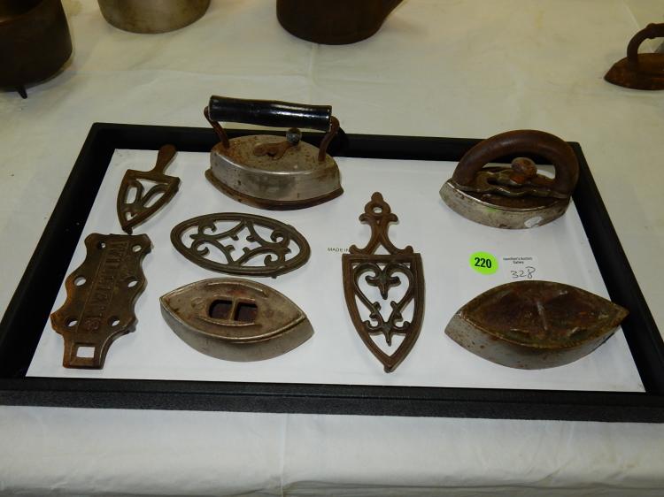 Tray of antique child's cast iron toy irons and trivets, no tray
