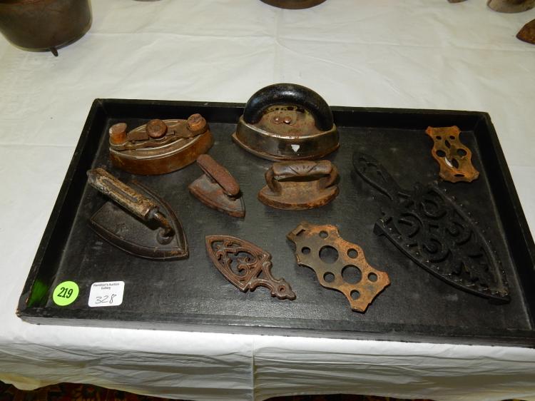 Tray of antique child's cast iron toy irons and trivets, no tray