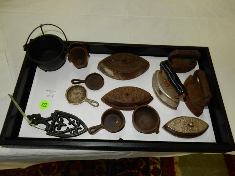 Tray of antique child's cast iron toy irons and trivets, no tray