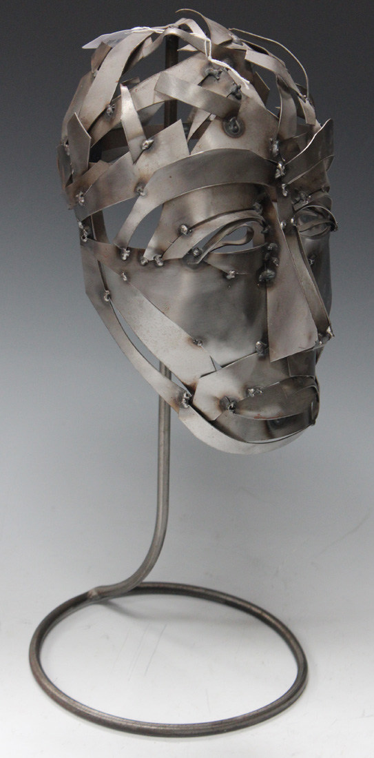 A MODERN WROUGHT METAL MODEL OF A STYLIZED HUMAN HEAD