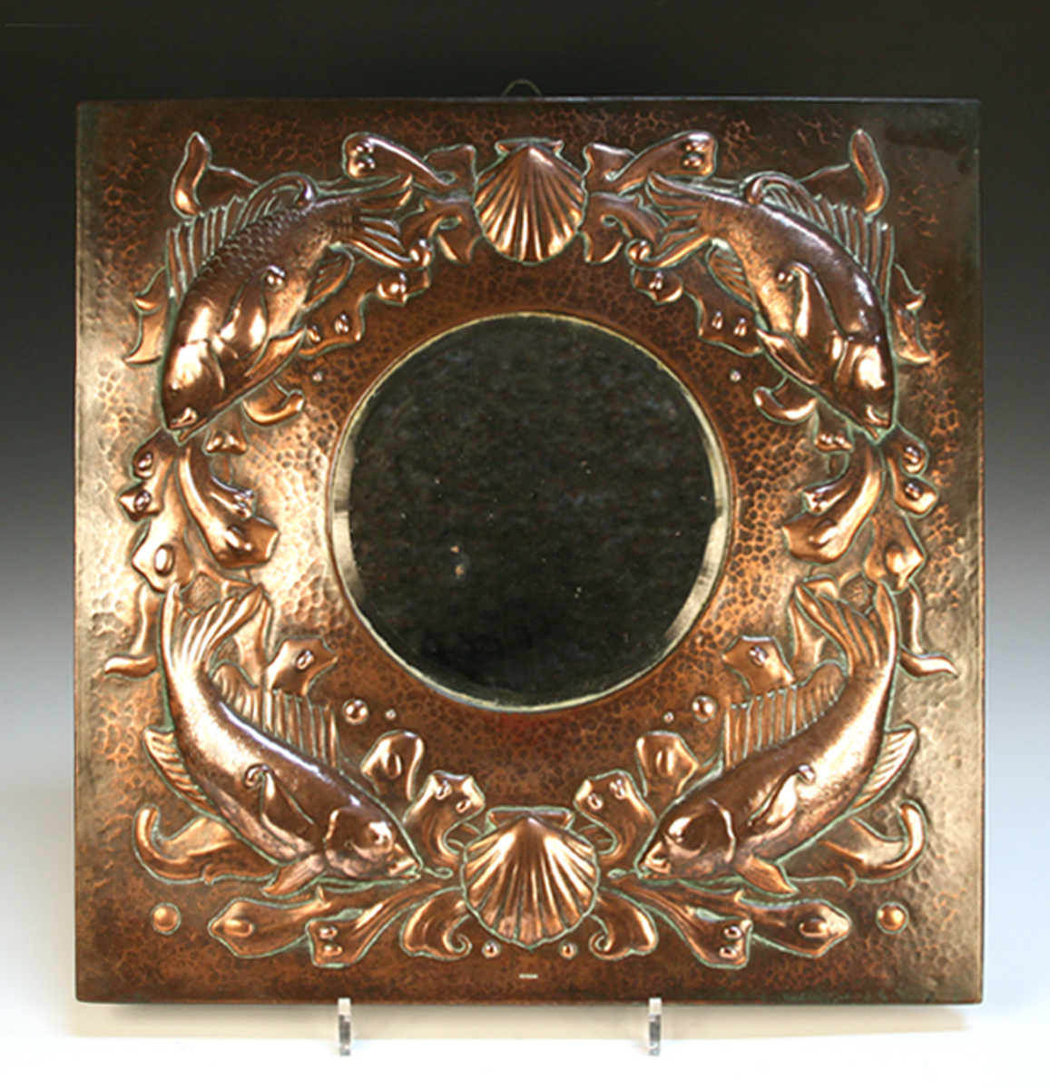 AN ARTS AND CRAFTS NEWLYN COPPER WALL MIRROR