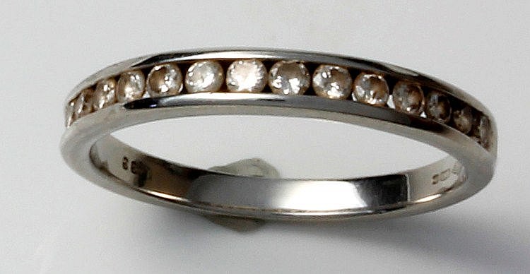 A platinum diamond set half eternity ring, channel