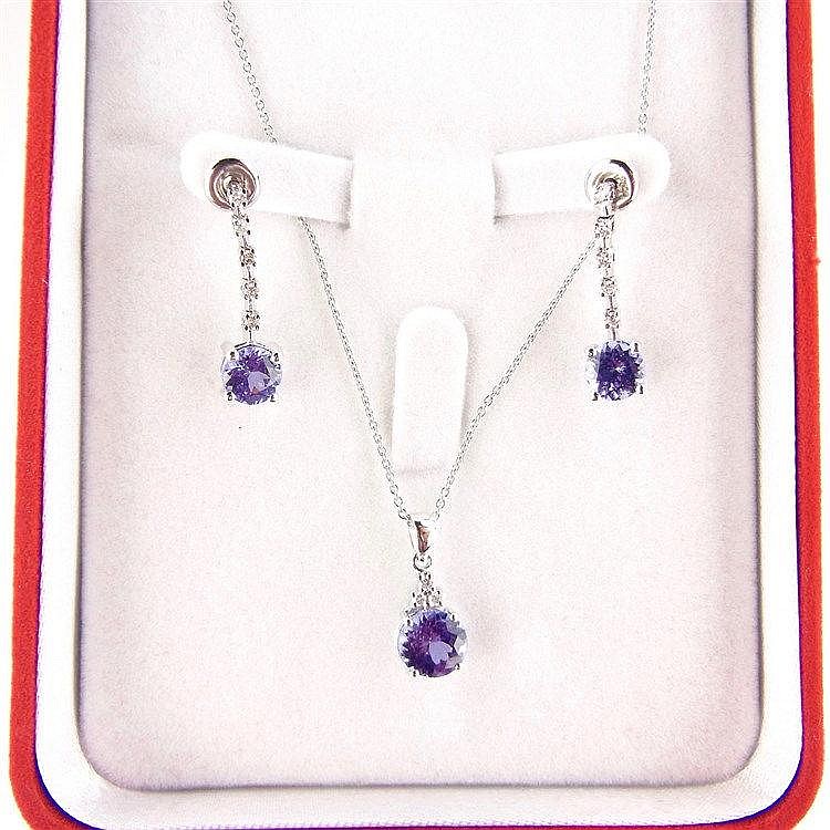18 ct white gold tanzanite and diamond pendant and earrings. The pendant se