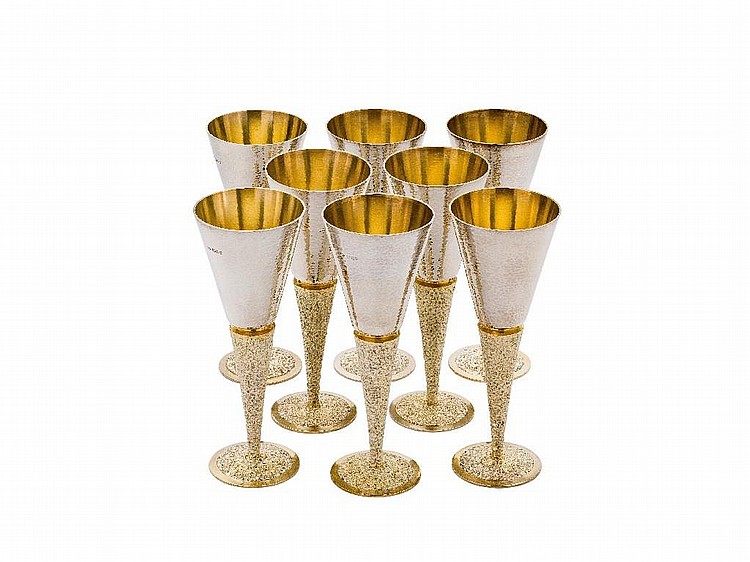 A SET OF EIGHT PARCEL-GILT-SILVER WINE GOBLETS,