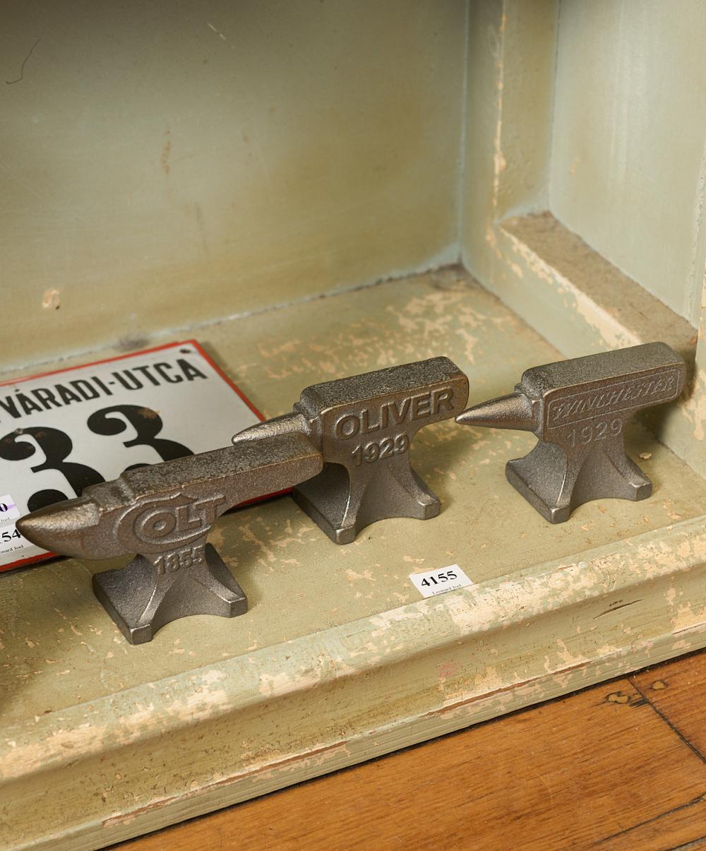 A GROUP OF THREE MINIATURE CAST IRON ANVILS