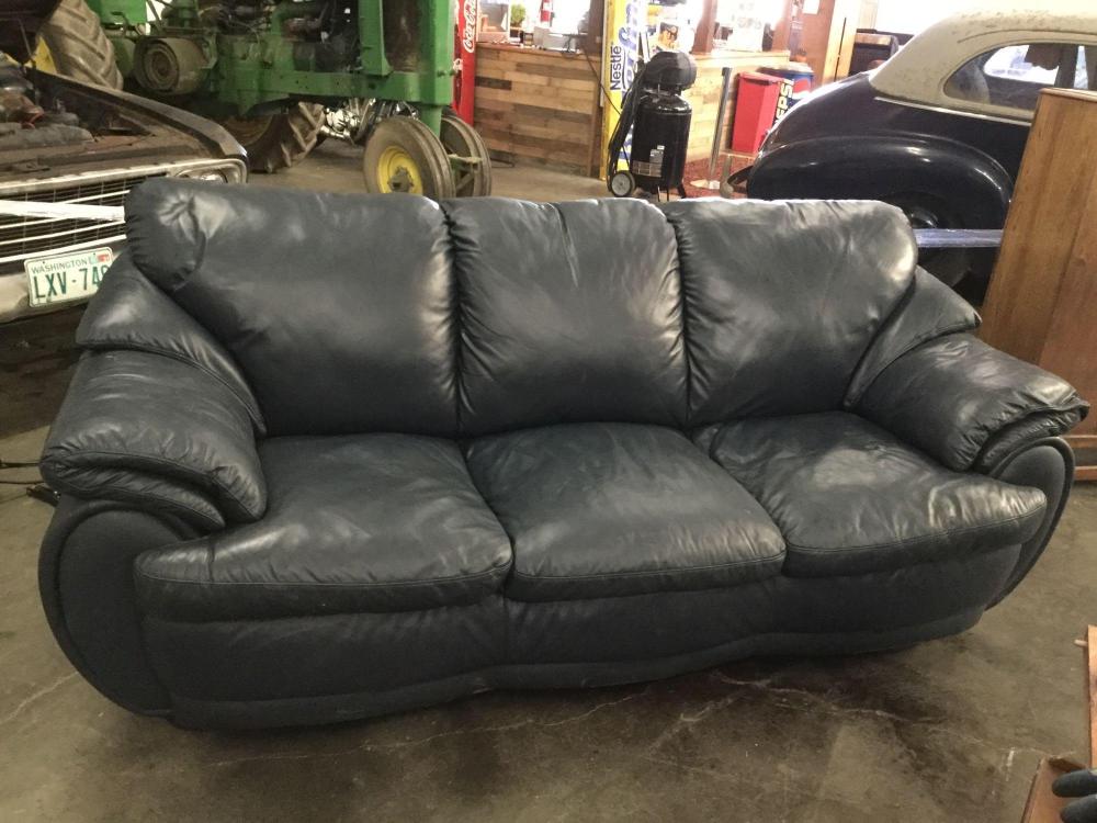 Navy blue faux leather couch with rounded edge modern design