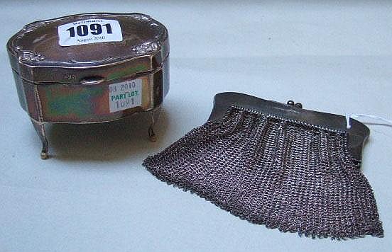 A silver shaped oval hinge lidded trinket box