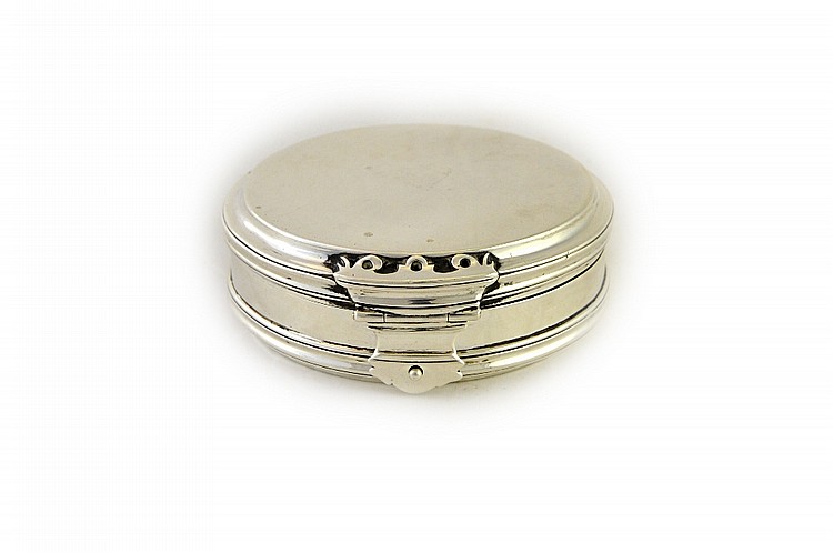 A silver circular hinge lidded box