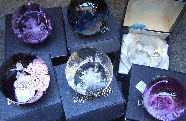 Four Caithness glass paperweights with coloured