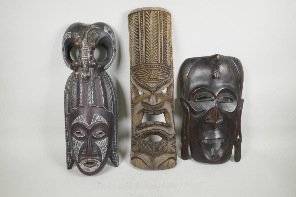 Three carved wood ethnic tribal masks, largest 21" long