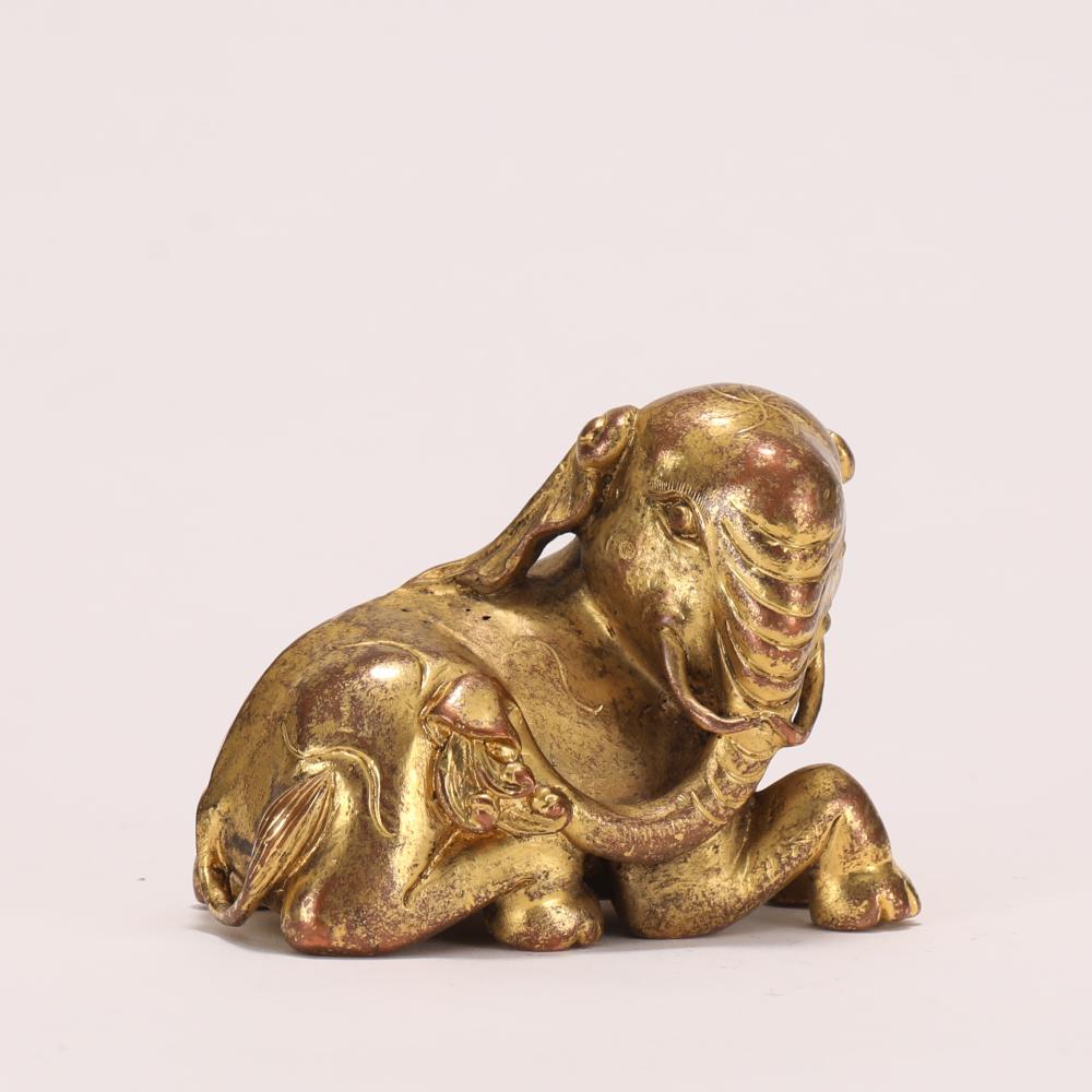 A CHINESE GILT BRONZE ELEPHANT