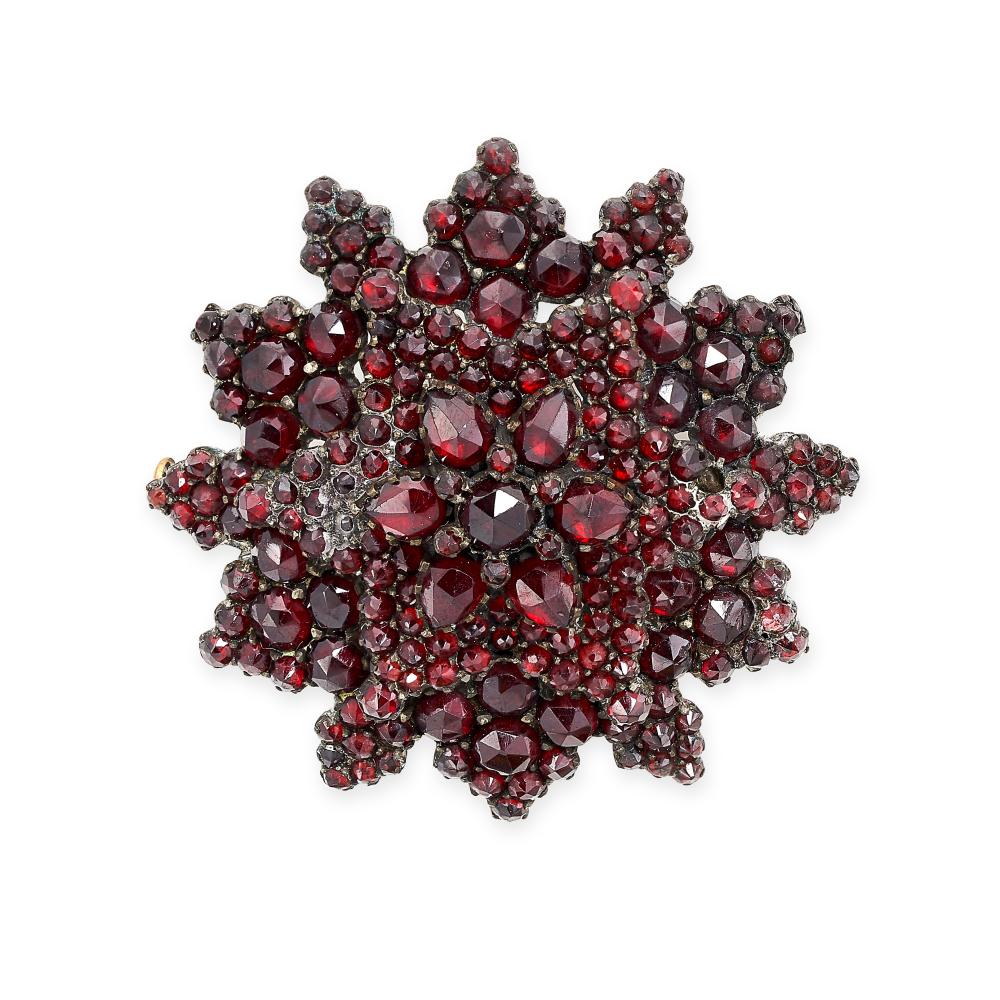 AN ANTIQUE BOHEMIAN GARNET SUNBURST BROOCH set throughout with rose cut garnets