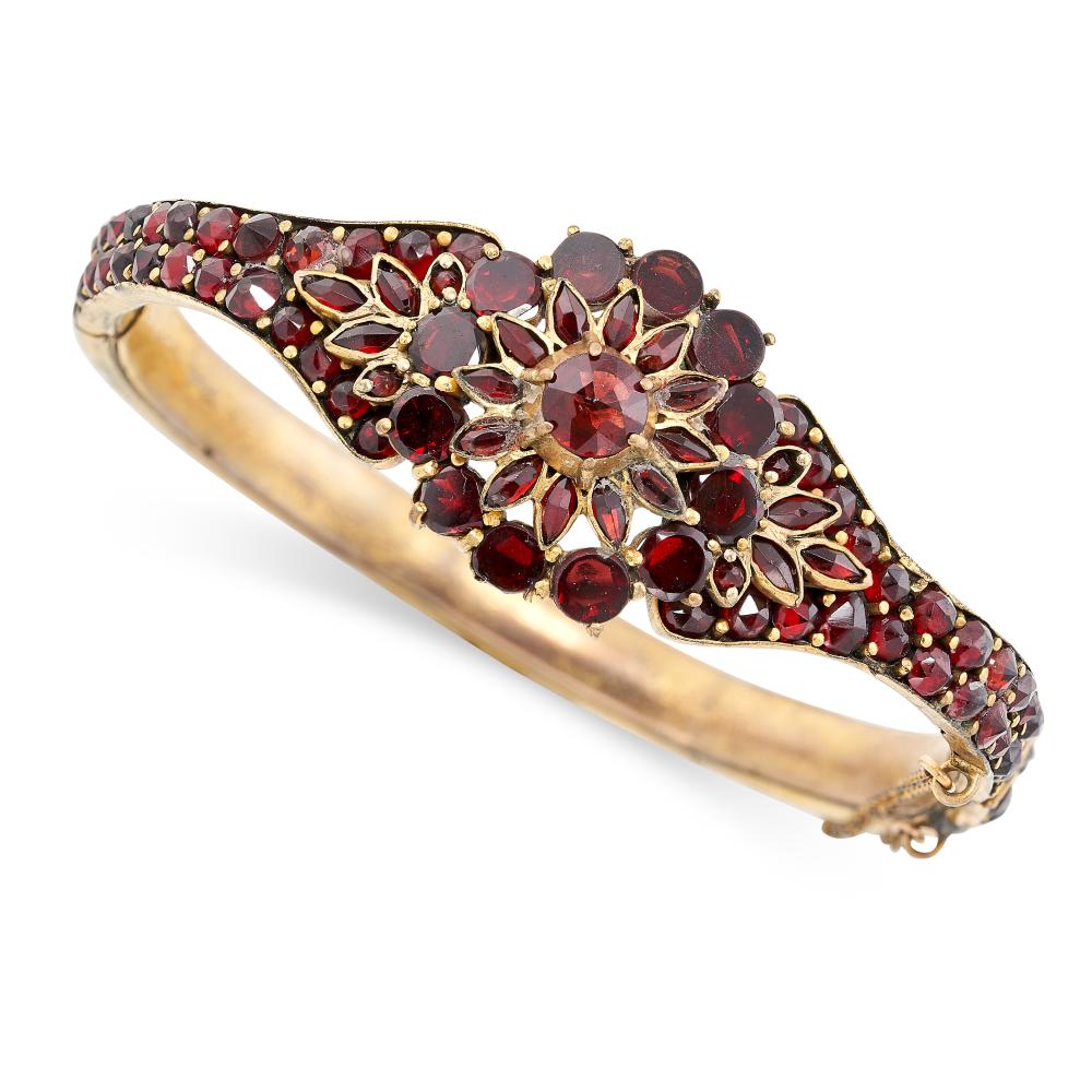 AN ANTIQUE BOHEMIAN GARNET BANGLE set throughout with rose cut garnets
