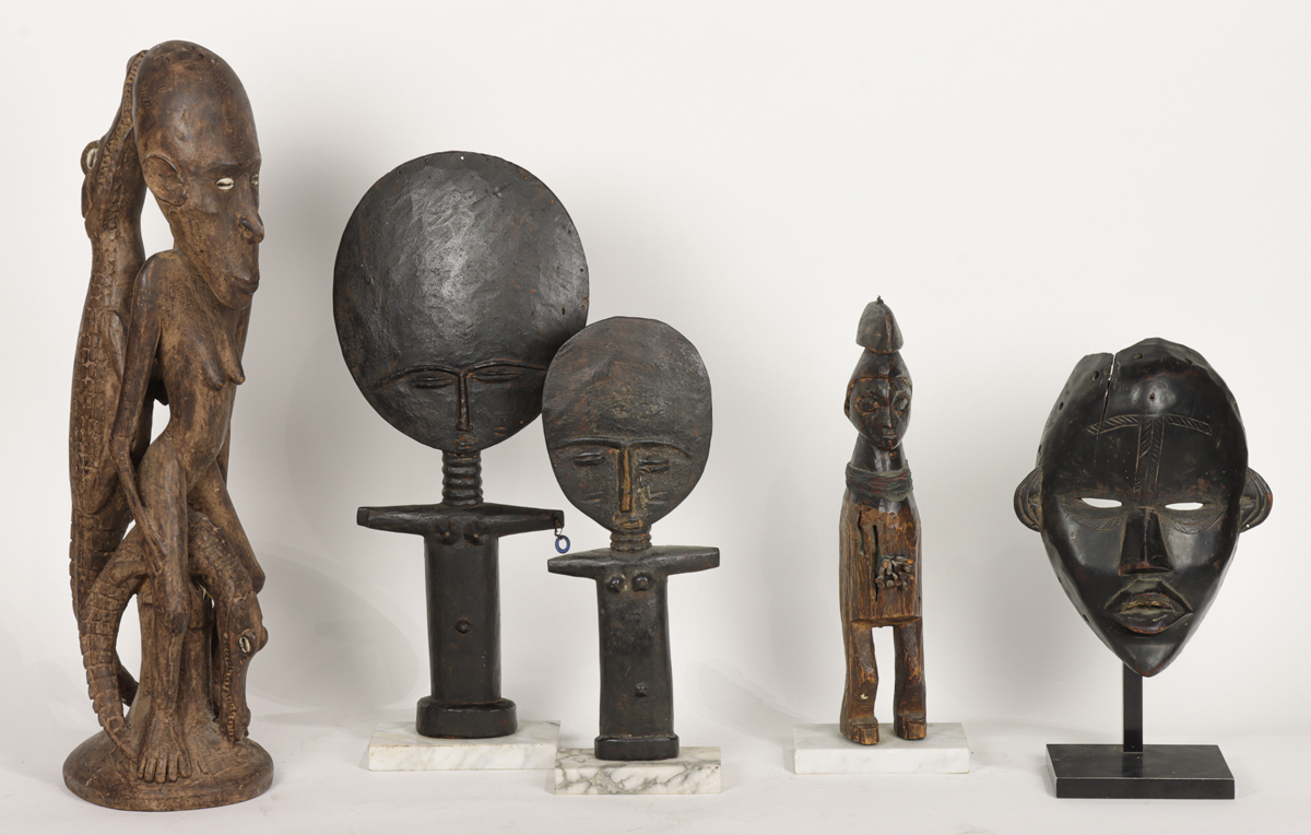 A group of four African figures and a mask