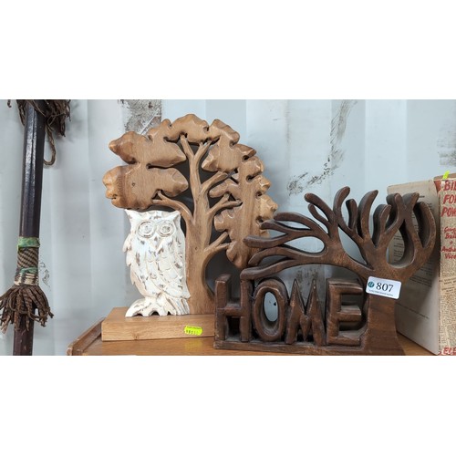 A group of carved wood décor including a freestanding “HOME”...
