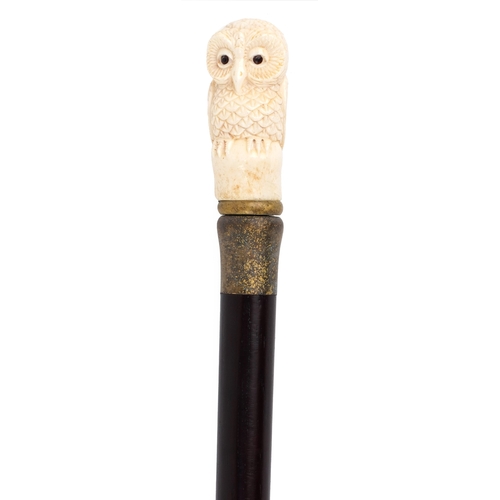 Hardwood walking stick with carved bone handle in the form o...
