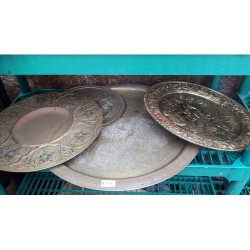 A group of Middle Eastern brass chargers and dishes, various...